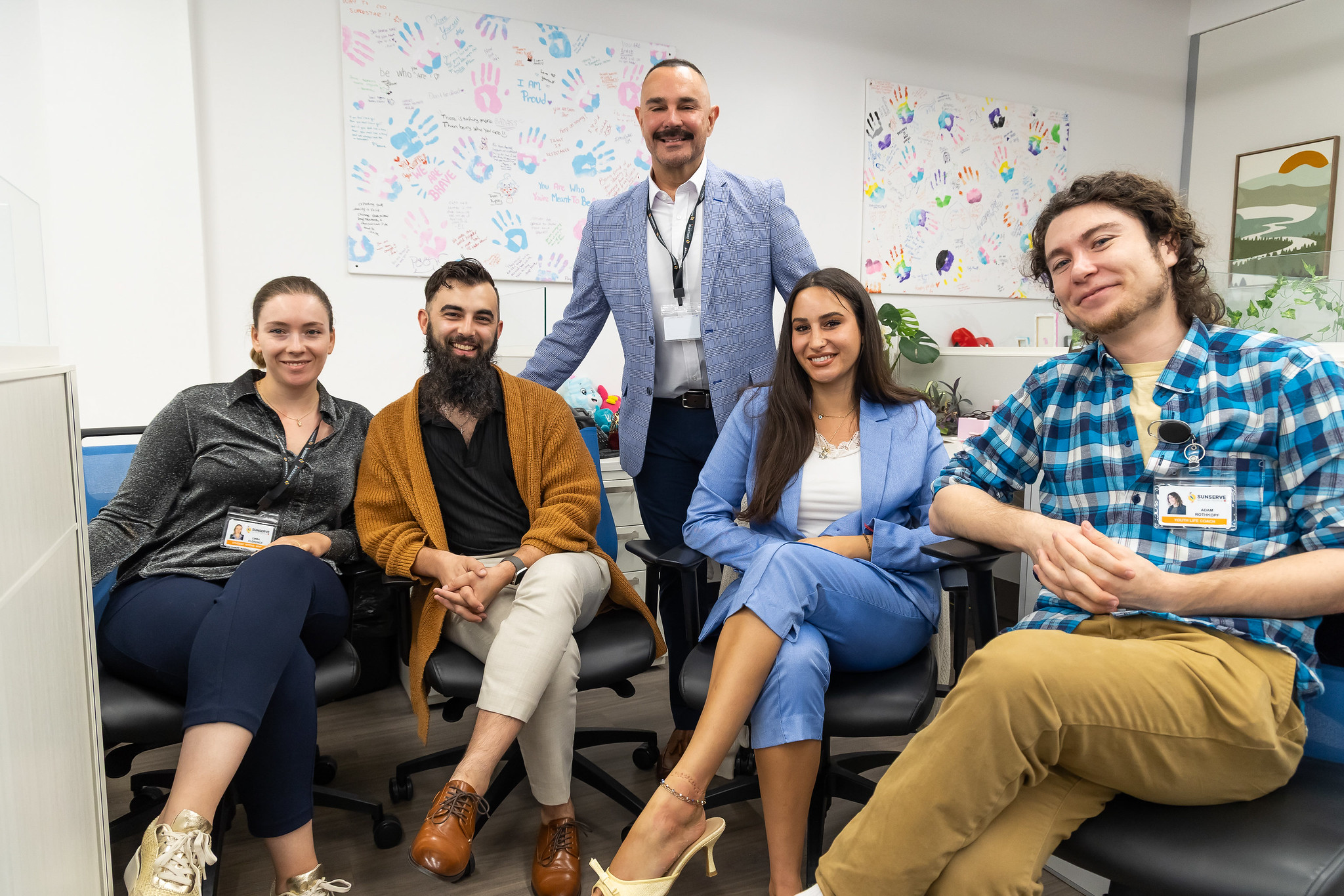 Sunserve staff sitting next to each other in the remodeled office space